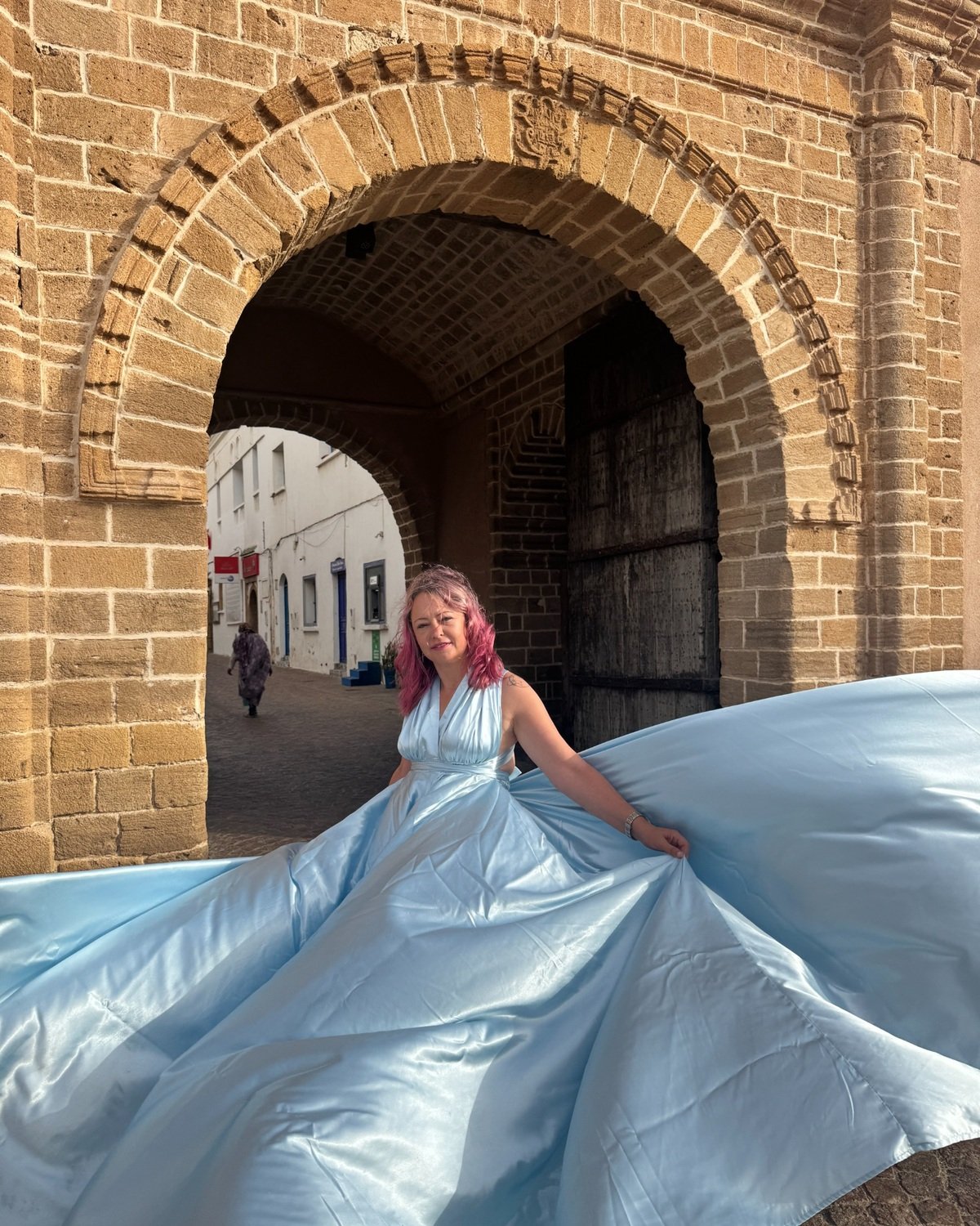 Chefchaouen flying dress at a Medina gate in Essaouira